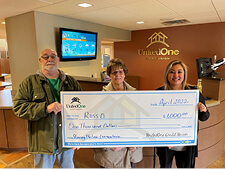 UnitedOne Branch Team Leader Donna (right) presents a "big" winning check to Ross, a UnitedOne member.