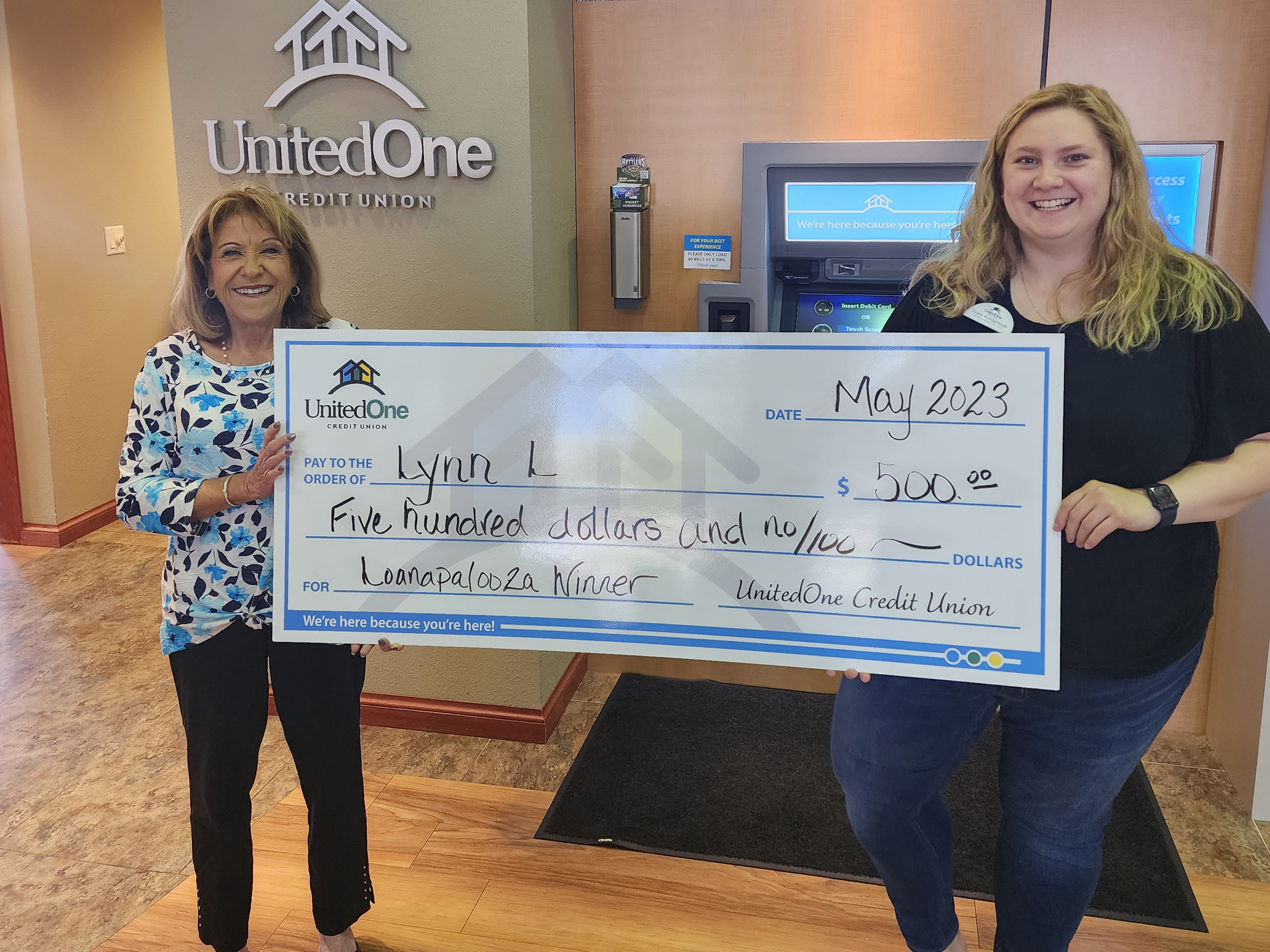 Lynn L. a winning UnitedOne Credit Union member, with Lexey, a MSR