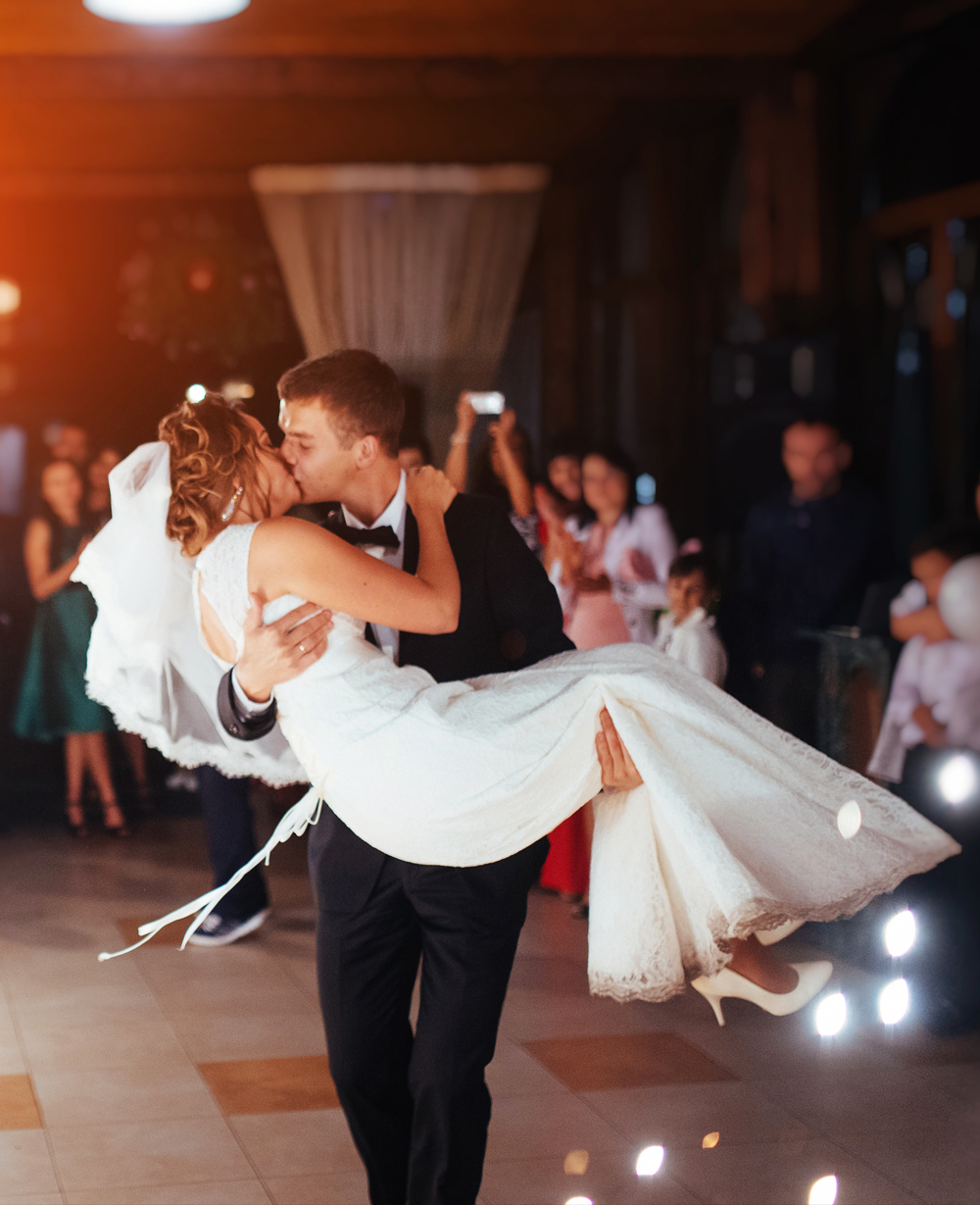 Groom kissing his bride on the dance floor
