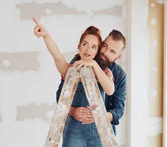 A couple in a room of house that is being remodeled