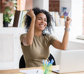Woman holding up arms and smiling